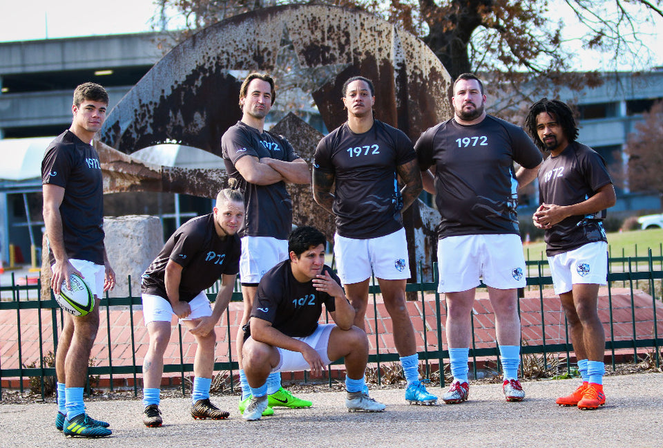 Team of rugby players posing for camera